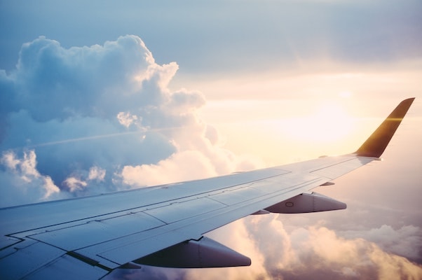 Airplane flying at sunrise